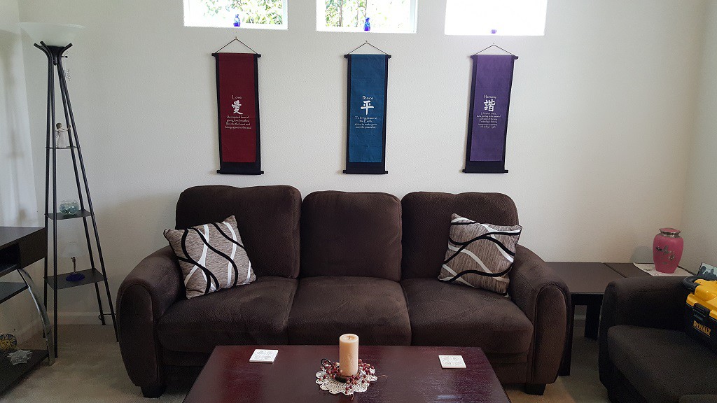 The side wall under the windows. The couch sits here now.